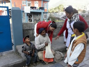 Distributing warm Pullover to a street Dweller